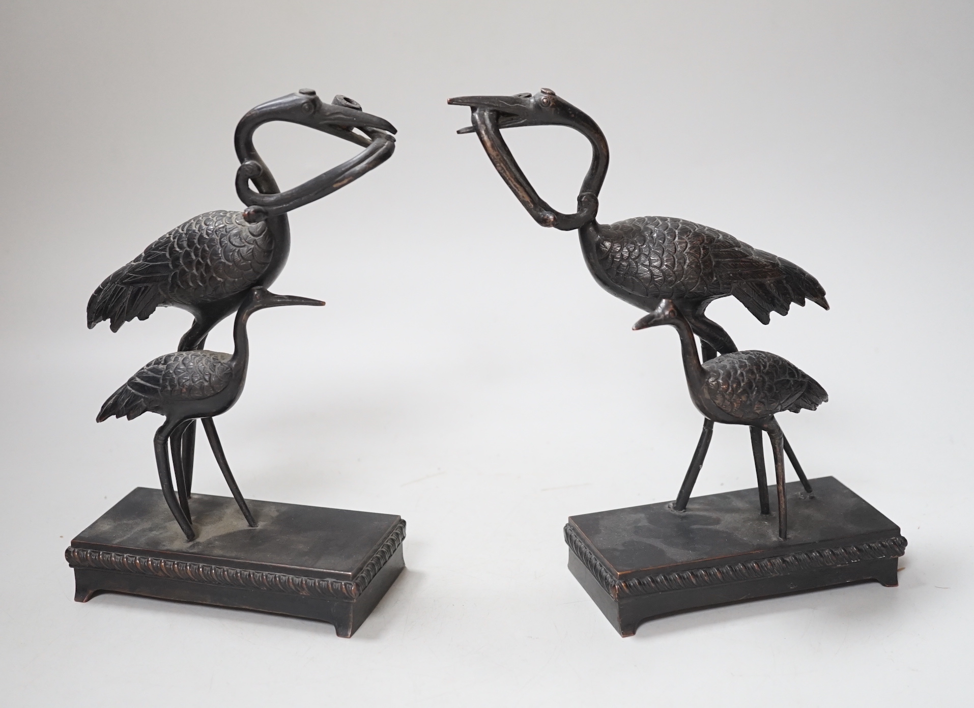 A pair of Japanese bronze crane figure groups, on later bases, 18cm high